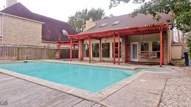 view of swimming pool featuring a patio area, a pergola, and an in ground hot tub