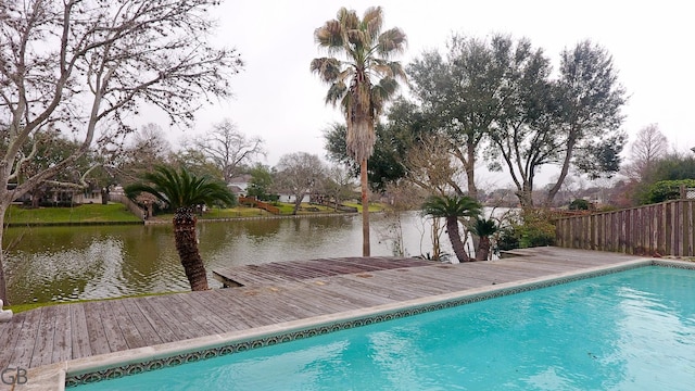 view of swimming pool with a deck with water view