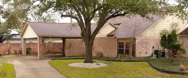 exterior space with central AC and a front yard