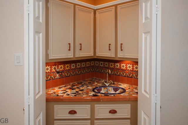 kitchen featuring sink and tile countertops