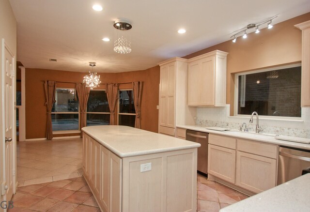 kitchen with hanging light fixtures, a center island, sink, and stainless steel dishwasher