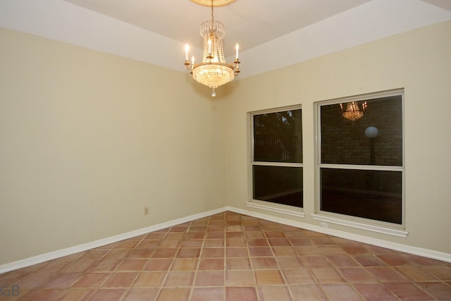 empty room featuring tile patterned flooring and an inviting chandelier