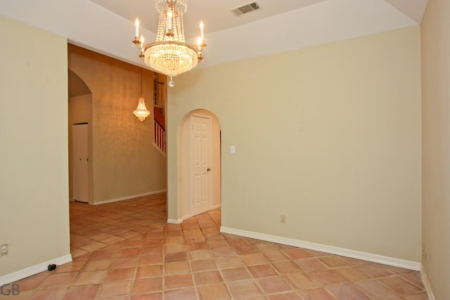 unfurnished room featuring a chandelier and light tile patterned floors