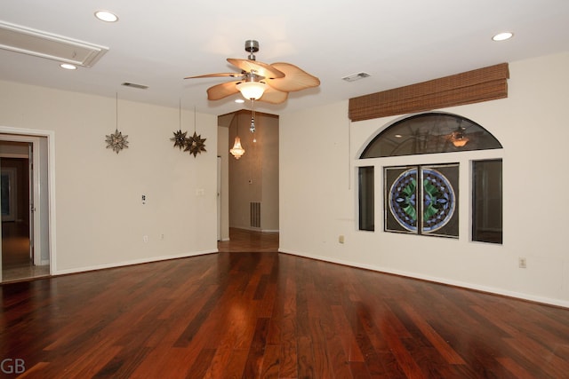 unfurnished room with ceiling fan and dark wood-type flooring