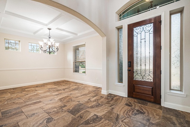 foyer featuring coffered ceiling, a notable chandelier, beam ceiling, and a healthy amount of sunlight