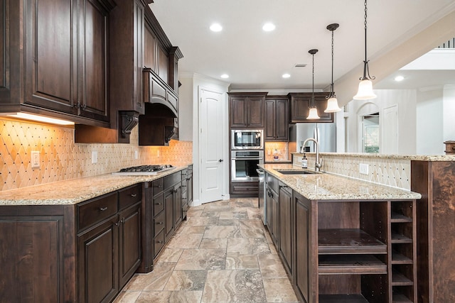 kitchen with appliances with stainless steel finishes, a large island, pendant lighting, and dark brown cabinetry