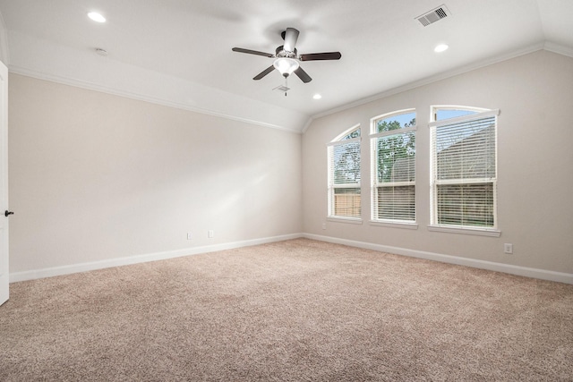 carpeted spare room featuring vaulted ceiling, ceiling fan, and crown molding