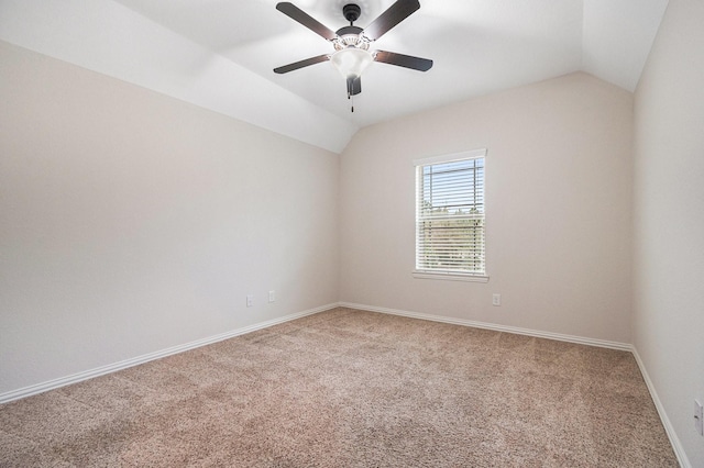 spare room featuring ceiling fan, carpet flooring, and vaulted ceiling