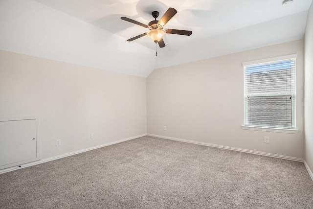 spare room featuring lofted ceiling, carpet flooring, and ceiling fan