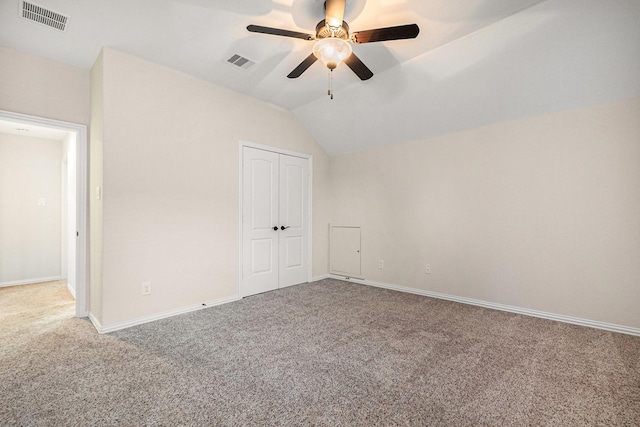 interior space featuring carpet floors, ceiling fan, and vaulted ceiling