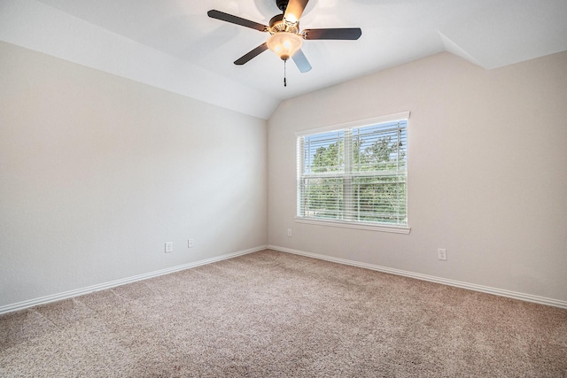 empty room with ceiling fan, lofted ceiling, and carpet floors