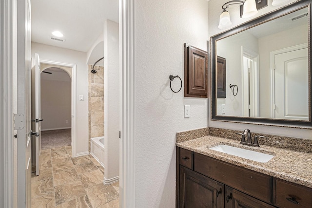 bathroom with vanity and  shower combination