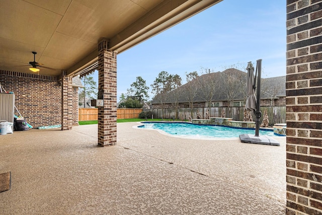 view of pool featuring pool water feature, a patio, and ceiling fan