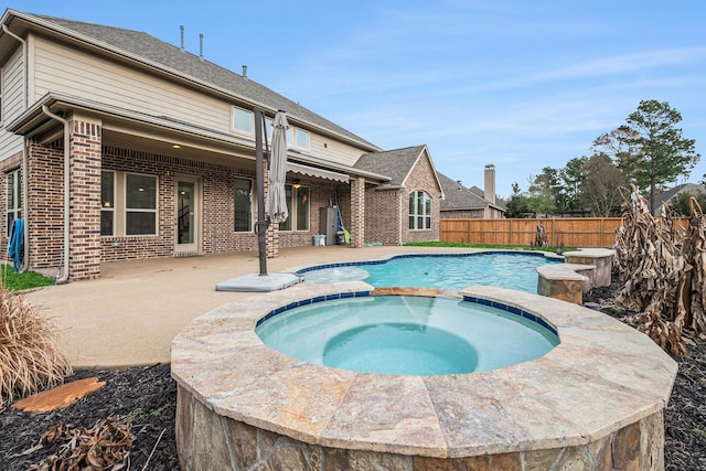 view of swimming pool with an in ground hot tub and a patio