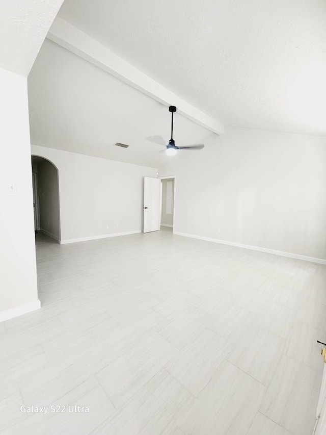 interior space featuring vaulted ceiling with beams, a textured ceiling, and ceiling fan