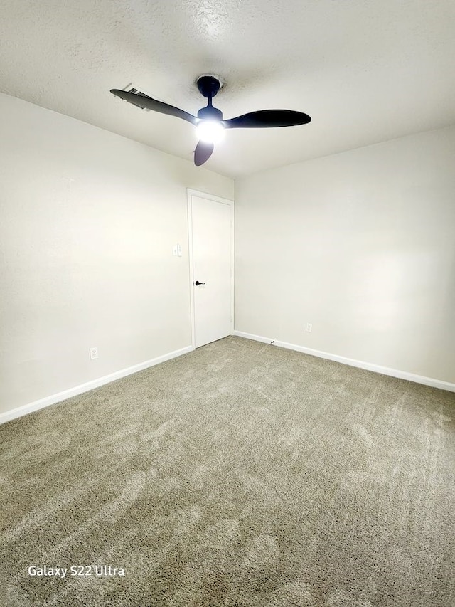 unfurnished room with carpet flooring, a textured ceiling, and ceiling fan