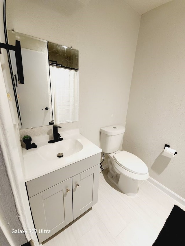 bathroom featuring vanity and toilet