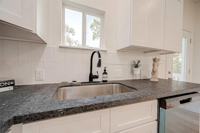 kitchen featuring dishwasher, sink, white cabinets, and decorative backsplash