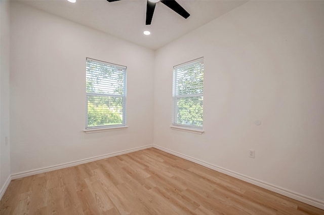 unfurnished room featuring ceiling fan, light hardwood / wood-style flooring, and a wealth of natural light