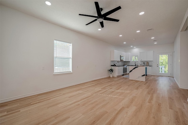 interior space featuring ceiling fan and light hardwood / wood-style flooring