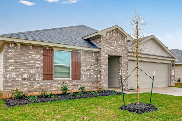 view of front of home featuring a garage and a front lawn