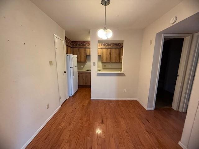 unfurnished dining area featuring dark wood-type flooring