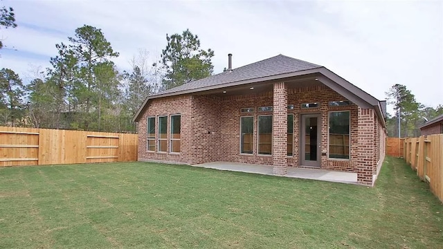 rear view of property with a patio area, a fenced backyard, a lawn, and brick siding