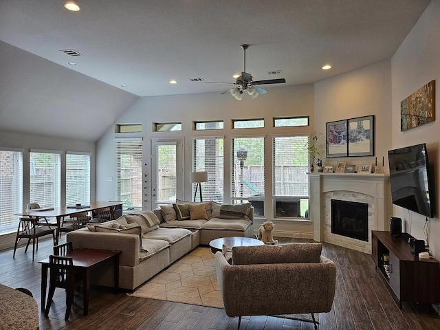 living room featuring recessed lighting, visible vents, a fireplace, and wood finished floors