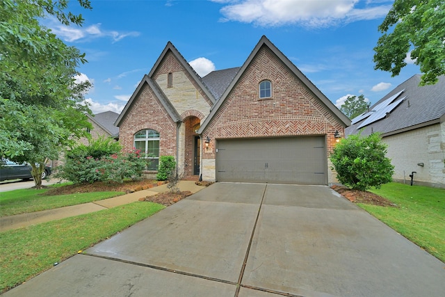 16715 Ramsay Cascades Dr, Humble, TX 77346 - view of front of house with brick siding, driveway, stone siding, and a front lawn