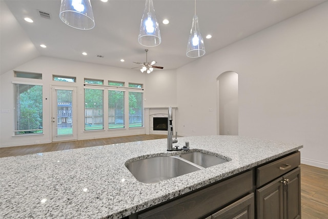 16715 Ramsay Cascades Dr, Humble, TX 77346 - kitchen with a sink, wood finished floors, ceiling fan, open floor plan, and decorative light fixtures