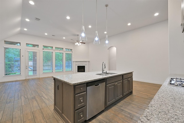 16715 Ramsay Cascades Dr, Humble, TX 77346 - kitchen with stainless steel dishwasher, open floor plan, a ceiling fan, a sink, and wood finished floors