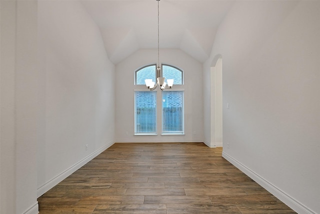 16715 Ramsay Cascades Dr, Humble, TX 77346 - unfurnished dining area with a chandelier, dark wood finished floors, vaulted ceiling, arched walkways, and baseboards