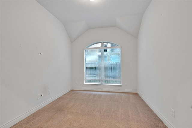 16715 Ramsay Cascades Dr, Humble, TX 77346 - empty room with light colored carpet, baseboards, and vaulted ceiling