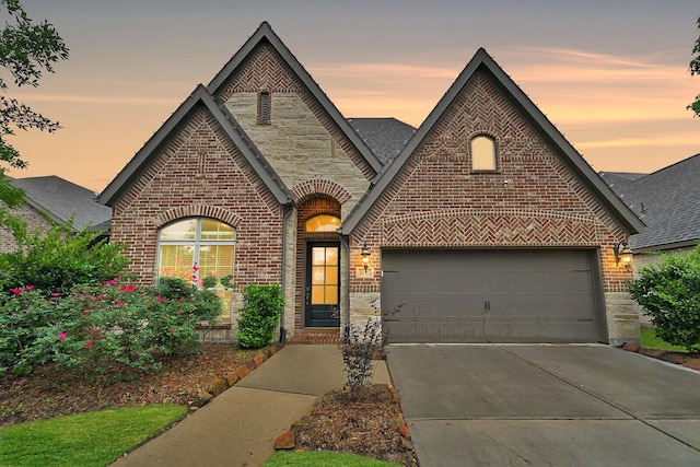 16715 Ramsay Cascades Dr, Humble, TX 77346 - french country style house featuring brick siding, driveway, a shingled roof, and stone siding