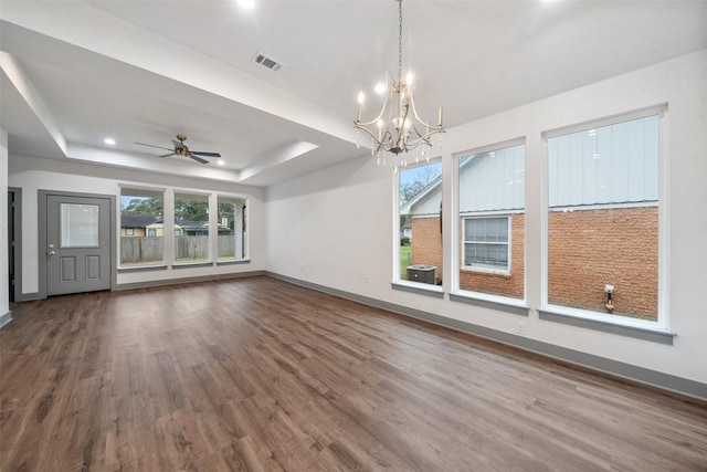 interior space featuring ceiling fan with notable chandelier, a raised ceiling, and hardwood / wood-style floors