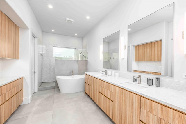 bathroom featuring tile patterned floors, separate shower and tub, and vanity