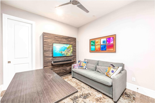 living room featuring ceiling fan and hardwood / wood-style floors