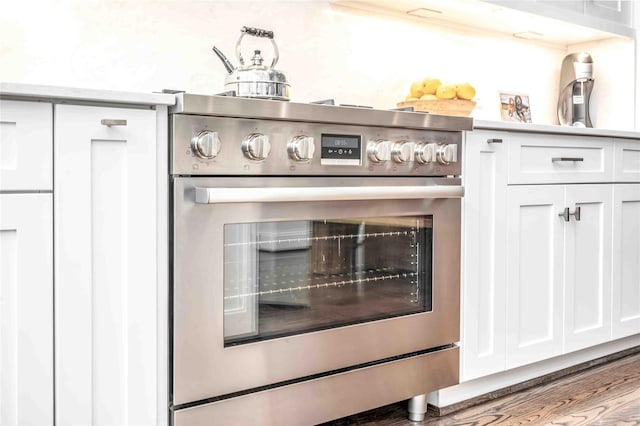 interior details featuring white cabinetry and stainless steel range oven