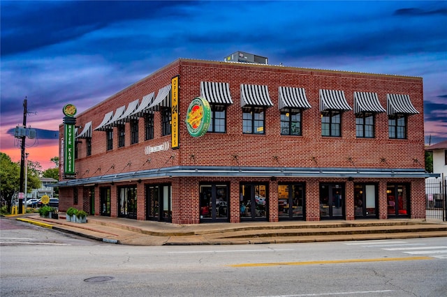 view of outdoor building at dusk