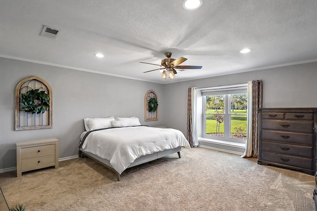 bedroom with light carpet, a textured ceiling, ornamental molding, and ceiling fan