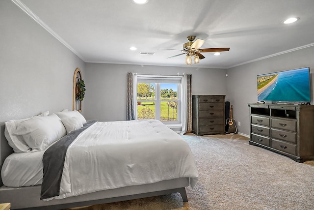 carpeted bedroom with ornamental molding and ceiling fan