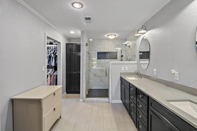 bathroom featuring ornamental molding, vanity, and a shower with door