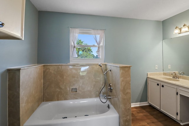 bathroom featuring vanity, a bath, and wood-type flooring