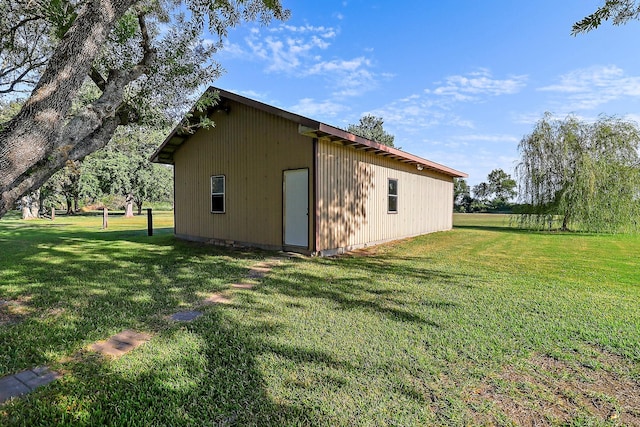 view of outbuilding with a yard