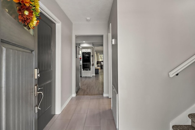 entryway with light tile patterned floors