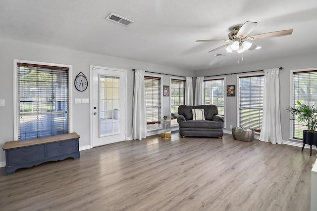 sitting room featuring hardwood / wood-style floors, a textured ceiling, and ceiling fan