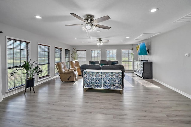 living room featuring ceiling fan and hardwood / wood-style floors