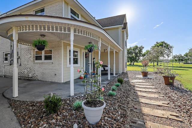 view of home's exterior with a porch and a patio area