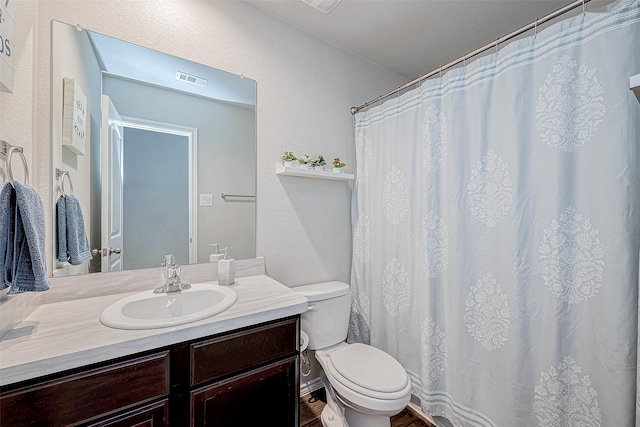 bathroom featuring vanity and toilet