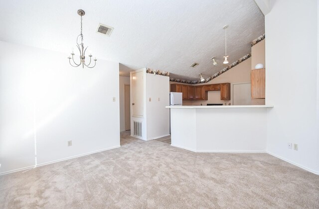 1478 Willow Wisp Dr, Missouri City, TX 77489 - unfurnished living room featuring light colored carpet, a textured ceiling, vaulted ceiling, and baseboards
